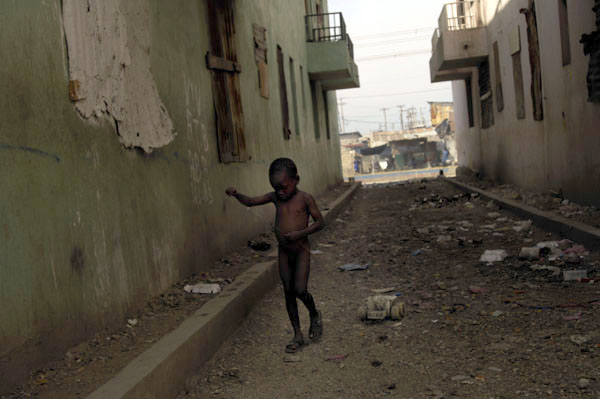 A young boy pulls his toy cart through the streets of La Saline. : Haiti 2006 : Jason DeCrow Photojournalist