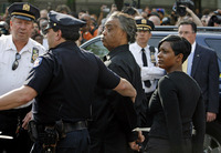 May 2008, New York, N.Y. - The Rev. Al Sharpton, center, and Nicole Paultre Bell, right, are led away in handcuffs after being arrested for blocking the Manhattan entrance to the Brooklyn Bridge to protest the acquittals of three detectives in the 50-bullet shooting of Sean Bell.  