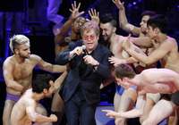 May 2010, New York, N.Y. - Sir Elton John is surrounded by dancers as he performs Madonna's "Like A Virgin"during the Rainforest Fund's 21st Birthday Celebration benefit concert at Carnegie Hall.