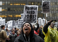 April 2009, New York, N.Y. - Protesters yell at people looking out the windows of an AIG office building during a rally against government bailouts for corporations. 