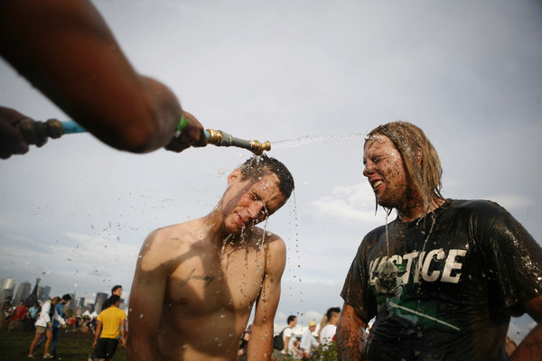 August 2009, New York, N.Y. - Concert goers get hosed off after dancing in a mud pit during the All Points West music festival at Liberty State Park. : Showbiz Singles : Jason DeCrow Photojournalist