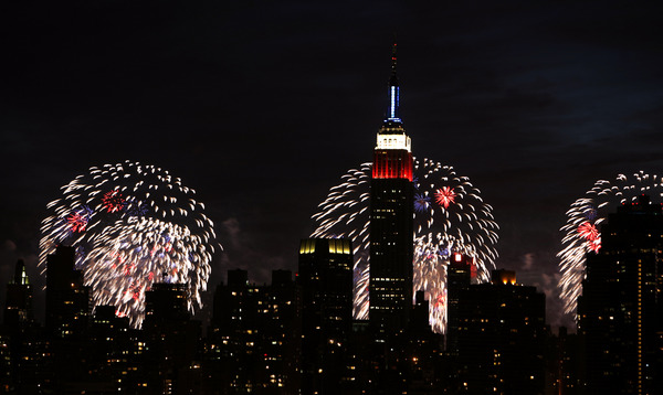 July 2009, Long Island City, N.Y. - The Empire State Building, seen from across the East River in the Queens borough of New York, is backlit by shells exploding over the Husdon River during the Macy's Fourth of July fireworks show. : News Singles : Jason DeCrow Photojournalist