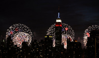 July 2009, Long Island City, N.Y. - The Empire State Building, seen from across the East River in the Queens borough of New York, is backlit by shells exploding over the Husdon River during the Macy's Fourth of July fireworks show.