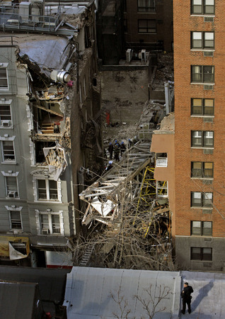 March 2008, New York, N.Y. - A section of collapsed crane lies atop a block of residential buildings on 50th Street near Second Avenue after toppling over at a nearby construction site. : News Singles : Jason DeCrow Photojournalist