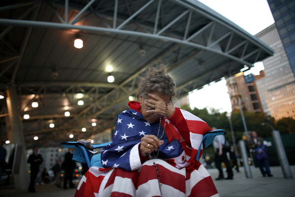 September 2006, New York, N.Y. - Delia Colon, of Hamilton Square, New Jersey, bows her head as she prays at Ground Zero near the end of an all-night vigil on the fifth anniversary of the Sept. 11 attacks.  : News Singles : Jason DeCrow Photojournalist