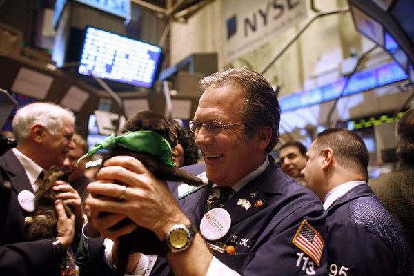 December 2008, New York, N.Y. - Holly, an orphaned puppy up for adoption, gets some attention from Thomas Kay after representatives of the Helen Woodward Animal Center and the Iams Home 4 the Holidays pet adoption campaign rang the opening bell at the New York Stock Exchange to celebrate the campaign's 966,284th adoption. : News Singles : Jason DeCrow Photojournalist