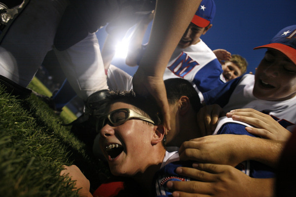 August 2006, Haverstraw, N.Y. - Mid Island pitcher Chris Goetz is mobbed by his teammates after the final out in Mid Island's 4-0 victory over Merrick/No. Merrick in Game 7 of the New York State Little League Baseball Tournament. : Sports Singles : Jason DeCrow Photojournalist
