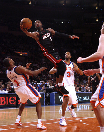 April 2010, New York, N.Y. - Miami Heat #3 Dwayne Wade draws a foul on his way to the basket against New York Knicks #1 Chris Duhon, left, during an NBA basketball game at Madison Square Garden. : Sports Singles : Jason DeCrow Photojournalist