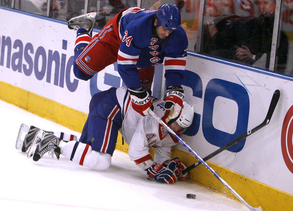 January 2009, New York, N.Y. - New York Rangers left wing Aaron Voros, top, battles for possession with Montreal Canadiens center Maxim Lapierre in the second period during an NHL hockey game at Madison Square Garden. : Sports Singles : Jason DeCrow Photojournalist