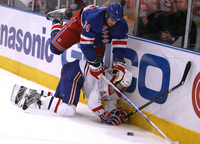 January 2009, New York, N.Y. - New York Rangers left wing Aaron Voros, top, battles for possession with Montreal Canadiens center Maxim Lapierre in the second period during an NHL hockey game at Madison Square Garden.