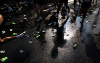 November 2005, Brooklyn, N.Y. - Runners are reflected on the wet pavement of a water station on Fourth Avenue in Brooklyn during the ING New York City Marathon.