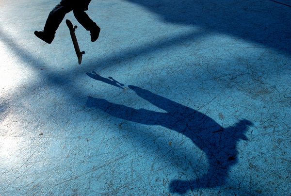 June 2005, NYC - A skateboarder kickflips through the shadows of the Unisphere in Flushing Meadows. : Singles : Jason DeCrow Photojournalist
