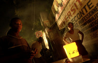 A woman sells fried plantains by night along a road in Delmas.