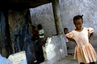 A young girl poses in her church clothes near her home in Cite Soleil.