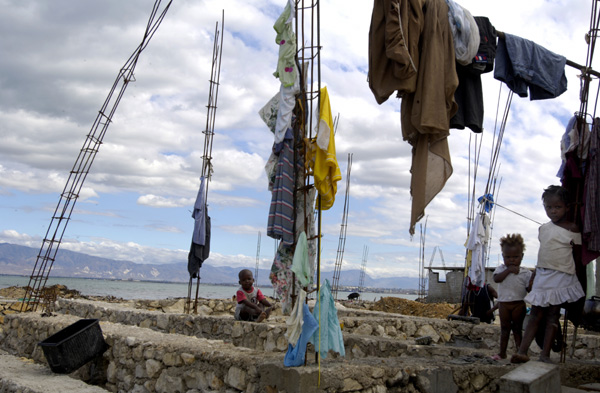 Laundry dries on the skeletons of unfinished housing in the seaside slum of Carrefour. : Haiti 2006 : Jason DeCrow Photojournalist