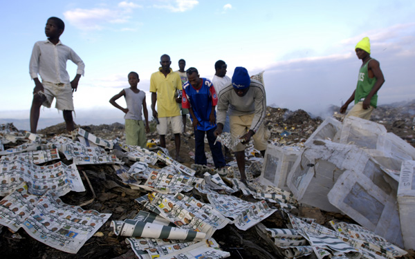 Residents of Cite Soleil pick through piles of ballots, some marked, that were found dumped in a huge landfill on the outskirts of Port-au-Prince. : Haiti 2006 : Jason DeCrow Photojournalist