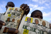 Residents of Cite Soleil show marked ballots found dumped in a huge landfill on the outskirts of Port-au-Prince.