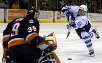 March 2006, Uniondale, NY - The New York Islanders' Rick DiPietro, left, saves a shot from the Toronto Maple Leafs' Alexei Ponikarovsky during a sudden death shootout at Nassau Coliseum. - © All images copyright Jason DeCrow