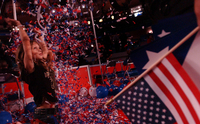 September 2004, New York, N.Y. - More interested in play than politics, Emily Morgan, 10, of Baton Rouge, La., frolics in one of many piles of confetti left after the finale of the Republican National Convention.