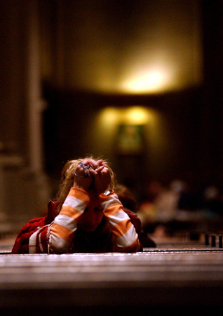 April 2005, NYC - A woman holds rosary beads as she mourns the loss of Pope John Paul II before a mass at Saint Patrick's Cathedral in Midtown. : Singles : Jason DeCrow Photojournalist