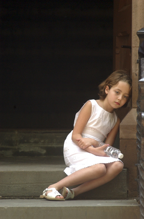 May 2004, New York, N.Y. - A young girl retreats from a hot and crowded funeral mass to quietly mourn the loss of a classmate who was struck and killed by  an SUV while riding her bike in Sunnyside. : News Singles : Jason DeCrow Photojournalist