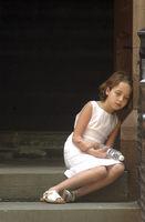 May 2004, New York, N.Y. - A young girl retreats from a hot and crowded funeral mass to quietly mourn the loss of a classmate who was struck and killed by  an SUV while riding her bike in Sunnyside.