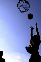 July 2005, Fresh Meadows, N.Y. - The setting sun casts golden light over a game of street basketball at Jewel Park in Fresh Meadows.