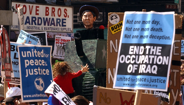 August 29, one day out - A mock tank driven by President George W. Bush rolls over a dummy protester on Seventh Avenue during the United For Peace and Justice Rally. : GOP in NYC 2004 : Jason DeCrow Photojournalist