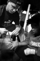 Almost all the kids that come into the NDYC have little or no boxing experience.  Here, boxing coach David Crowell shows Trent Whitley, 
14, the right way to wrap his hands before drilling.