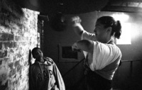 Amid the dust and rust of the NDYC, younger fighters learn from older 
ones--especially as David's appearances become less and less frequent.  Here, Marquise Jones, 11, watches Kate's speedbag 
technique.