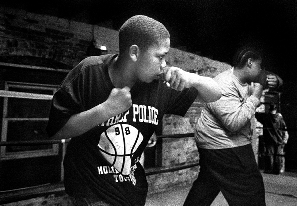 For kids like Marquise and Trent, fighting at the NDYC means not having to fight on the streetcorners of the Dudley Triangle.  Under the gym's flickering flourescent lights, the two work their left hooks. : Fighting the Streets : Jason DeCrow Photojournalist